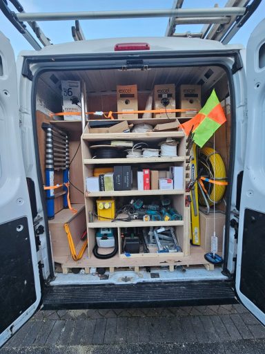 Neatly organised tools and equipment inside the back of a van.